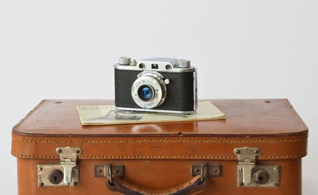 A suitcase with a camera on top
